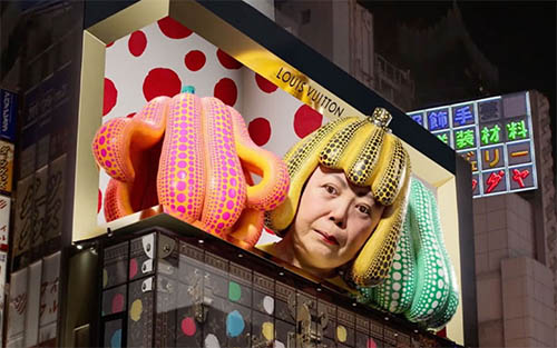 Giant 3D Yayoi Kusama head watching over the Louis Vuitton building in Shinjuku, Tokyo
