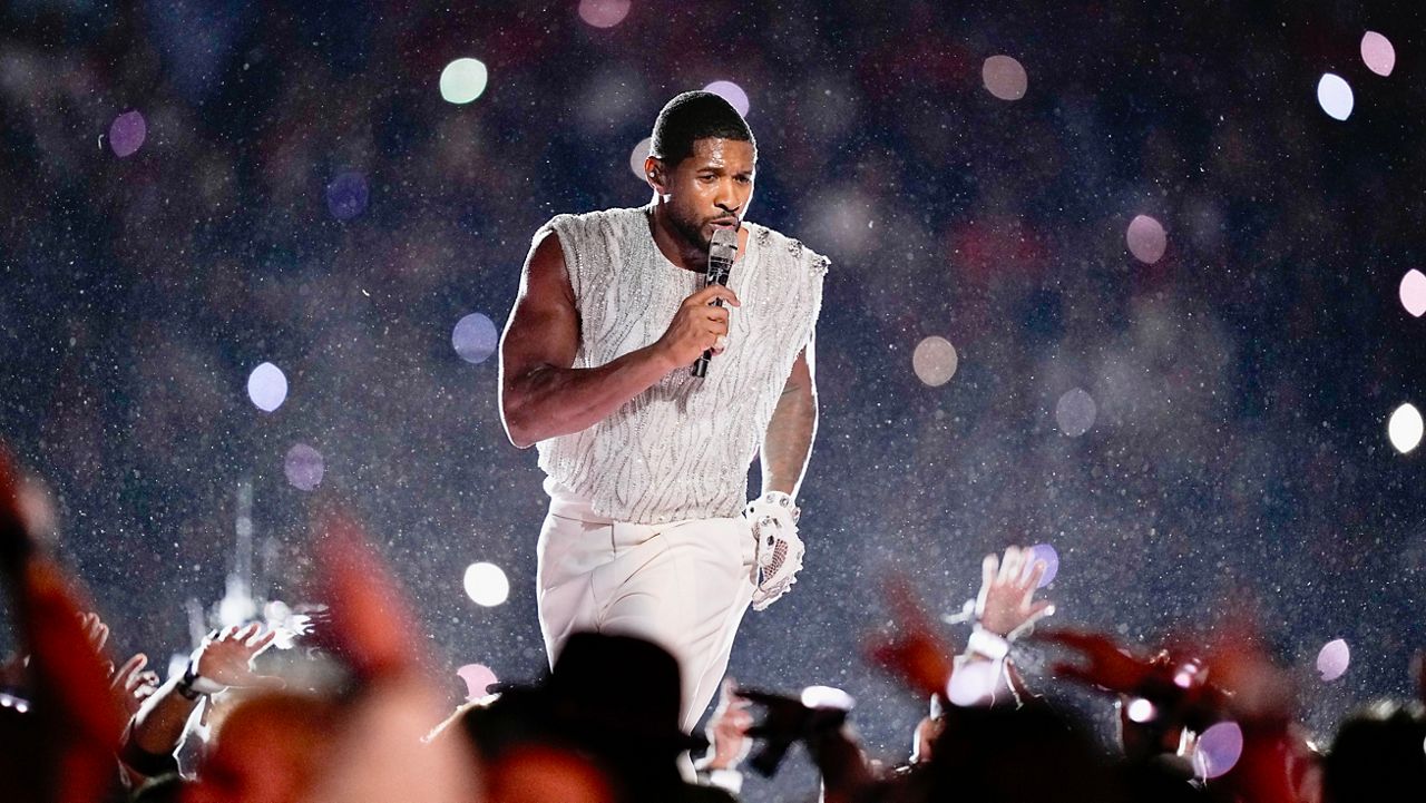 Usher wearing leather gloves embroidered with Swarovski crystals and pearls
