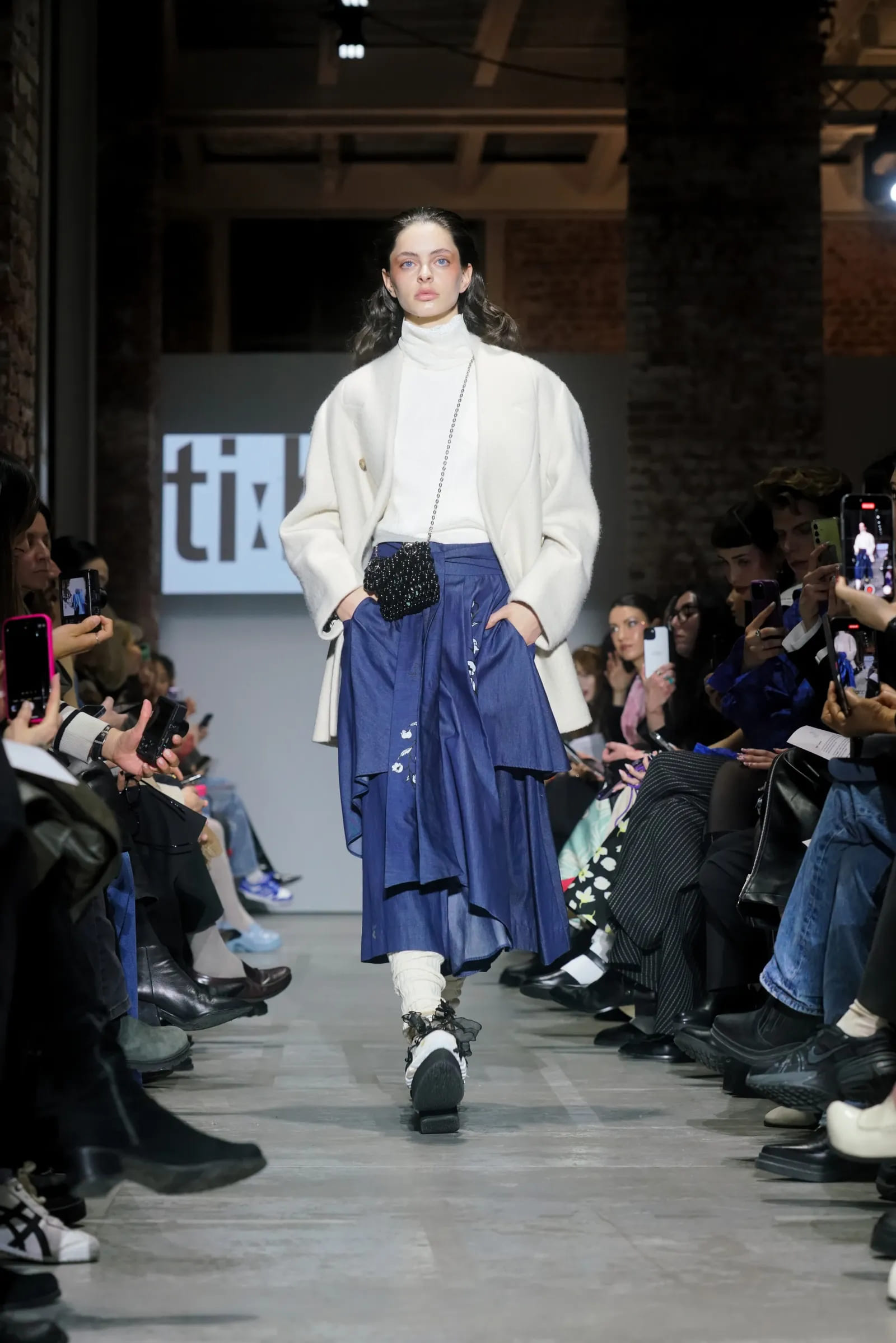 Tibaeg outfits in beige and lime green tones on the catwalk