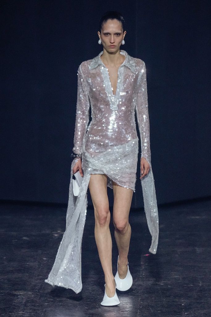 Model with lacquered hair on Coperni's space-age runway