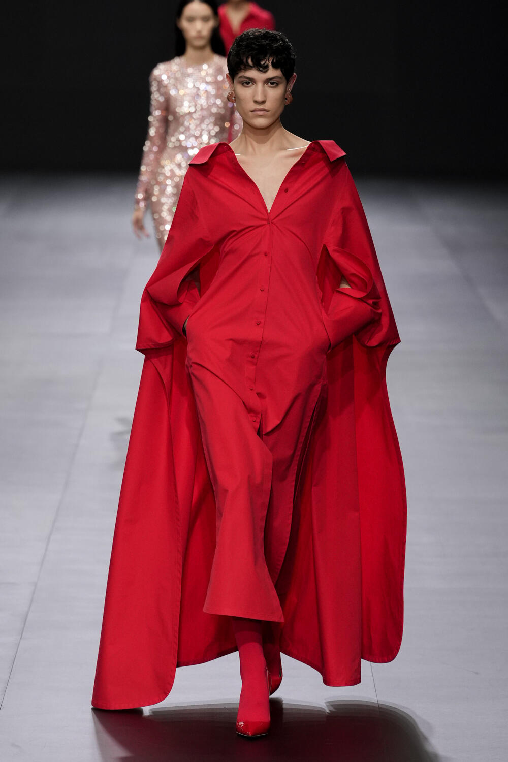 Pierpaolo Piccioli beside a gown from his creative era at Valentino