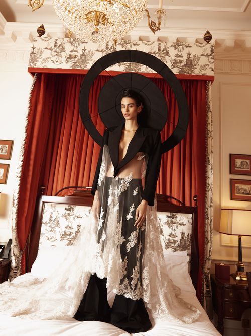 Sleeveless tuxedo jacket styled with jewel ear cuff and bracelet